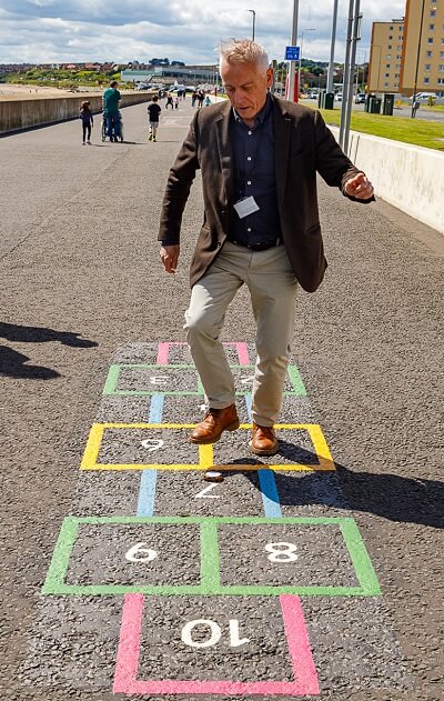 Man playing hopscotch