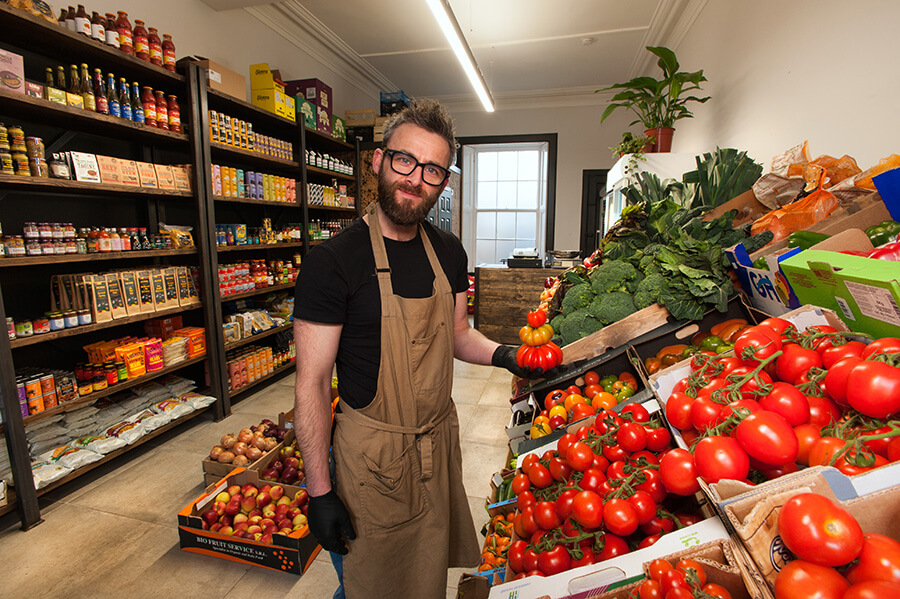 Friendly staff member in grocer shop