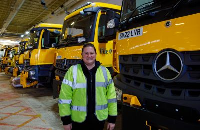 gritter driver in front of gritting lorries