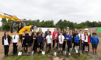 Local children help to cut the first sod