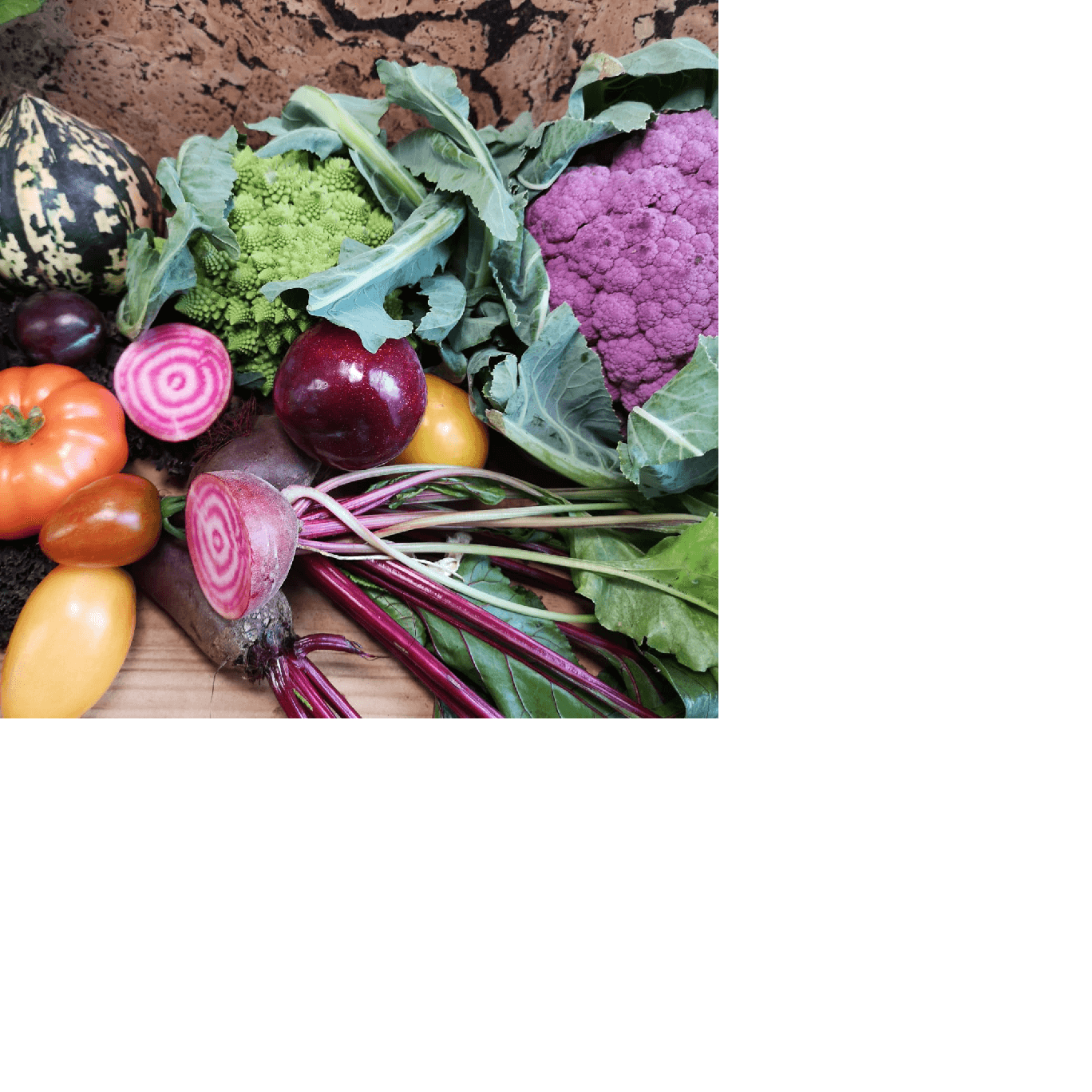 A colourful selection of healthy vegetables including peppers, beetroot, cauliflower, tomatoes, and potatoes.