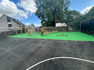 Playground at Lochgelly South Primary with a green area with play equipment