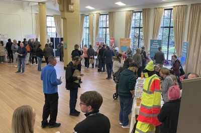 Staff and visitors in large hall attending jobs fair