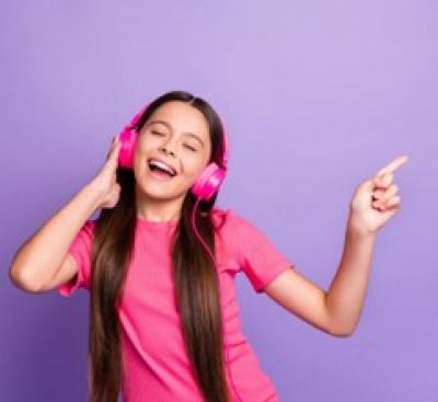 Young girl dancing with headset on