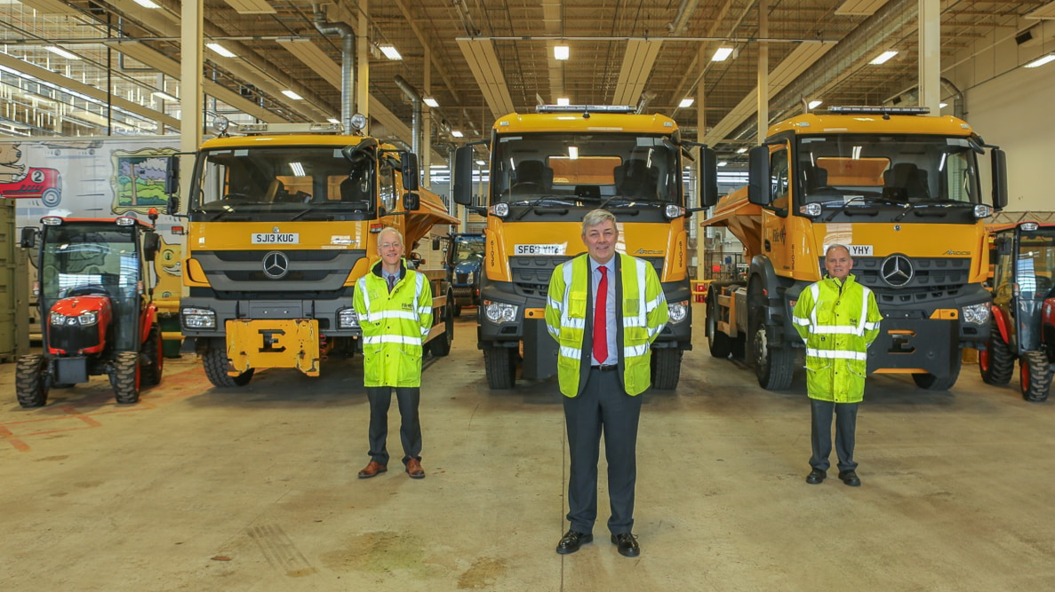 Staff standing in front of gritters