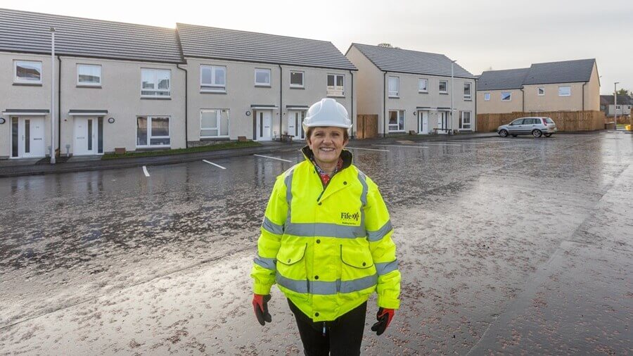 Councillor Judy Hamilton outside new build council houses